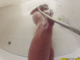 Amateur female Naomi soaps up her big tits and bush in the shower