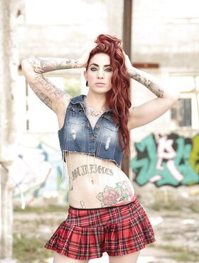 Outdoor posing from an tattooed redhead with nice boobs Sheena Rose