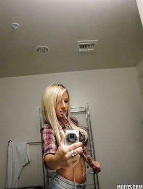 Perky blondie with piercing undressing and making selfies in the bath