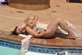 Shapely brunette Eva disrobes to show her big tits & ass by the pool