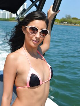 Brunette beauty Jade Jantzen on boat in thong bikini and sunglasses