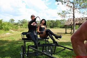 Femdoms Esmi Lee & Venus give a lesson to their naked muscular slave outdoors