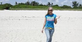 Blonde beach babe Britney Brooks posing fully clothed in denim jeans