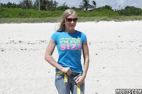 Blonde beach babe Britney Brooks posing fully clothed in denim jeans