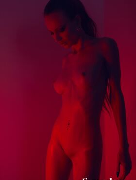 Blonde Jolie Webb peels off her black lingerie to show her naked slender body