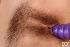 European chick Mia slides a purple dildo up her all natural vagina