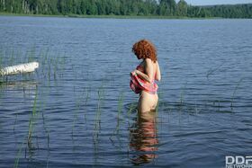 Beautiful redhead teen Sunny having fun and masturbating outdoor in a lake