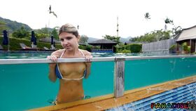 Slim teen Gina Gerson looses her small titties from a bikini by a pool