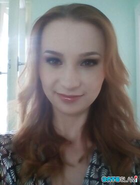 Young redhead Radka takes clothed and topless selfies around her place
