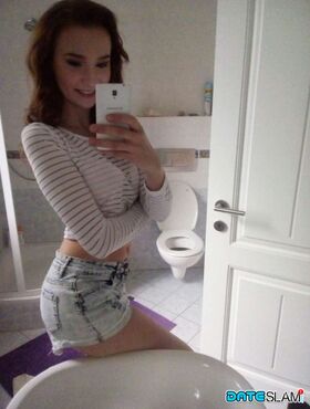 Young redhead Radka takes clothed and topless selfies around her place