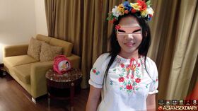 Asian amateur Aziza wears a crown of flowers during sex with a Farang