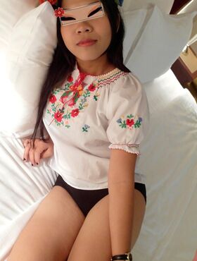 Asian amateur Aziza wears a crown of flowers during sex with a Farang