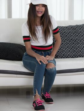 Petite Thai girl Mint removes ripped jeans to display her pussy in stockings