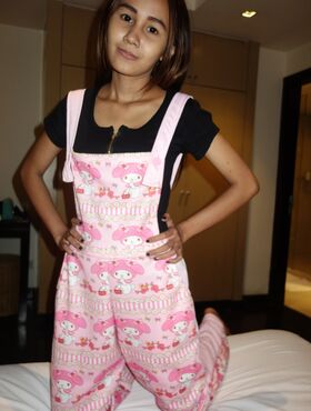 Slim Thai girl Puy is convinced to let her small boobs loose from her overalls