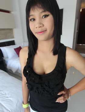 Cute Asian Jang displays her natural tits while wearing sexy thong panties