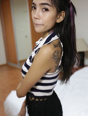 Skinny Thai girl with tattoos and braces makes her nude modelling debut