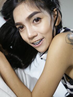 Skinny Thai girl with tattoos and braces makes her nude modelling debut