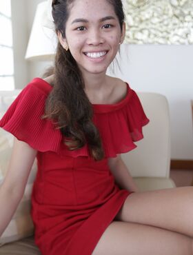 Cute first timer from Thailand poses in her red dress prior to modeling gig