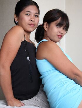 Asian ladies Che and Charm pose in motel for a sex tourist