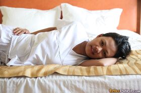 Lusty filipina nurses Joanna and Joy pose on the bed in their white uniforms