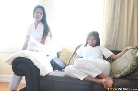 Lusty filipina nurses Joanna and Joy pose on the bed in their white uniforms