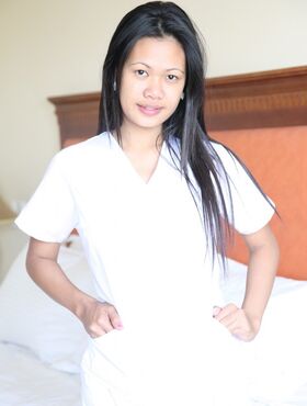 Lusty filipina nurses Joanna and Joy pose on the bed in their white uniforms