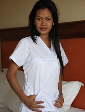 Lusty filipina nurses Joanna and Joy pose on the bed in their white uniforms