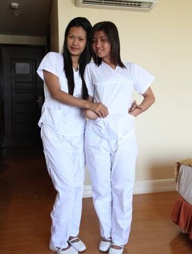 Lusty filipina nurses Joanna and Joy pose on the bed in their white uniforms