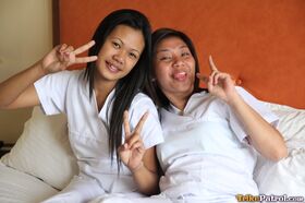 Lusty filipina nurses Joanna and Joy pose on the bed in their white uniforms