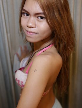Cute Thai babe Fresh Muay displays her petite body by doing a striptease
