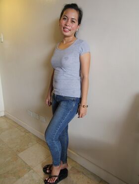 Brunette Filipina hottie Mercy shows off her big butt wrapped in jeans