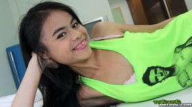 Petite Thai teen Ann2 puts the focus on her twat as she lays naked on a bed