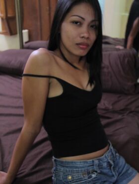 Filipina prostitute Analyn strips naked on a motel bed for a sex tourist