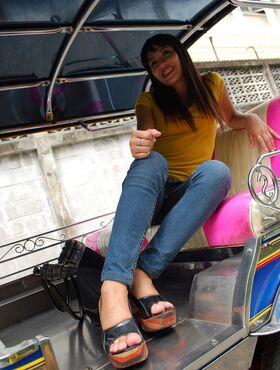 Female Tuk Tuk driver and a Farang ham it up for the camera in a back alley