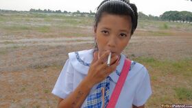 Smoking Filipina schoolgirl Sally opens her uniform to reveal sweet teen tits
