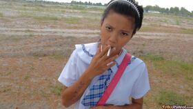 Smoking Filipina schoolgirl Sally opens her uniform to reveal sweet teen tits