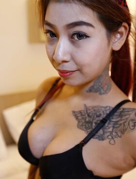 Tattooed Thai female with big tits gets banged by a foreigner in motel room