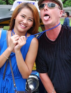 Beautiful Thai girl Mon flirting with a cute male tourist in public