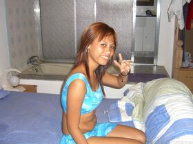 Filipina amateur takes off her clothed for her first nude shoot on a bed