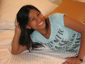 Smiley Filipina Jenny does a striptease to show her hairy vagina on the bed