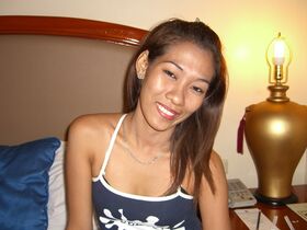 Asian first timer makes her nude debut on top of white bed sheets