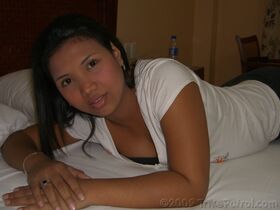 Asian amateur undresses on a bed before blowing and riding a sex tourist