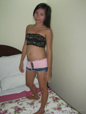 Petite Filipina girl undresses before having sexual intercourse with a Farang
