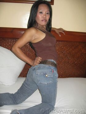 Filipina amateur slides denim jeans over thong covered ass as she gets naked