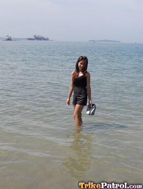 Asian girl Chelsy wades in the sea before making her nude debut on a bed