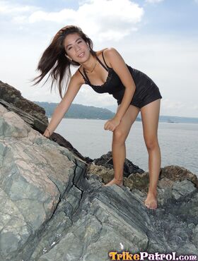 Asian girl Chelsy wades in the sea before making her nude debut on a bed