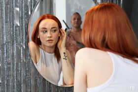 Skinny redhead Sheryl X gets wet down with a showerhead prior to having sex