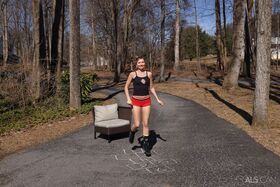 Athletic teen Emma Sirus masturbates on a driveway before taking a piss