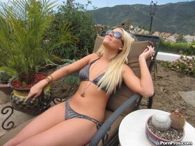Young blond in a bikini and sunglasses is called indoors to service a big cock