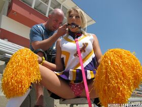 Blonde cheerleader Shawna Lenee is freed from ball gag to suck cock
